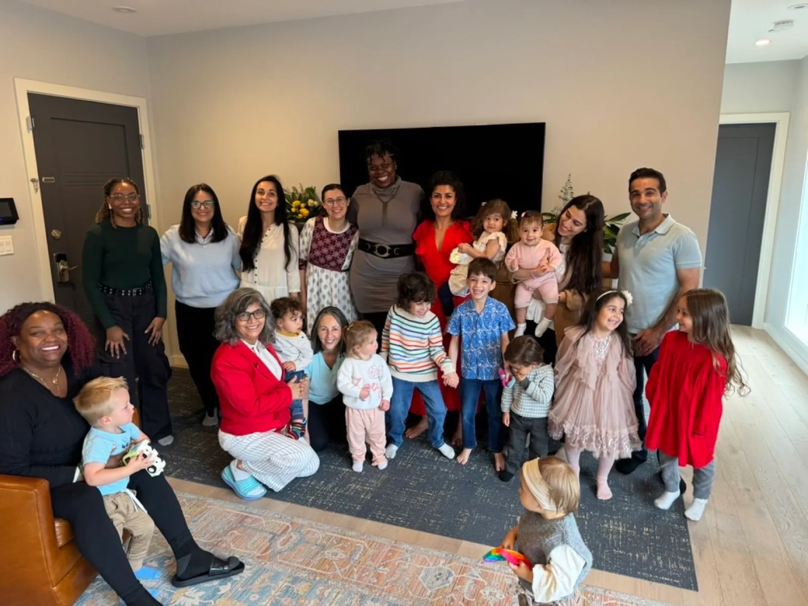Families gathered in a living room for community study