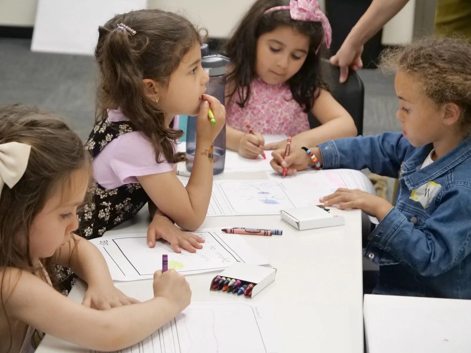 Children drawing together at a character class art table
