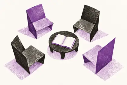 four purple and charcoal folded-paper chairs surrounding a round table with an open book.