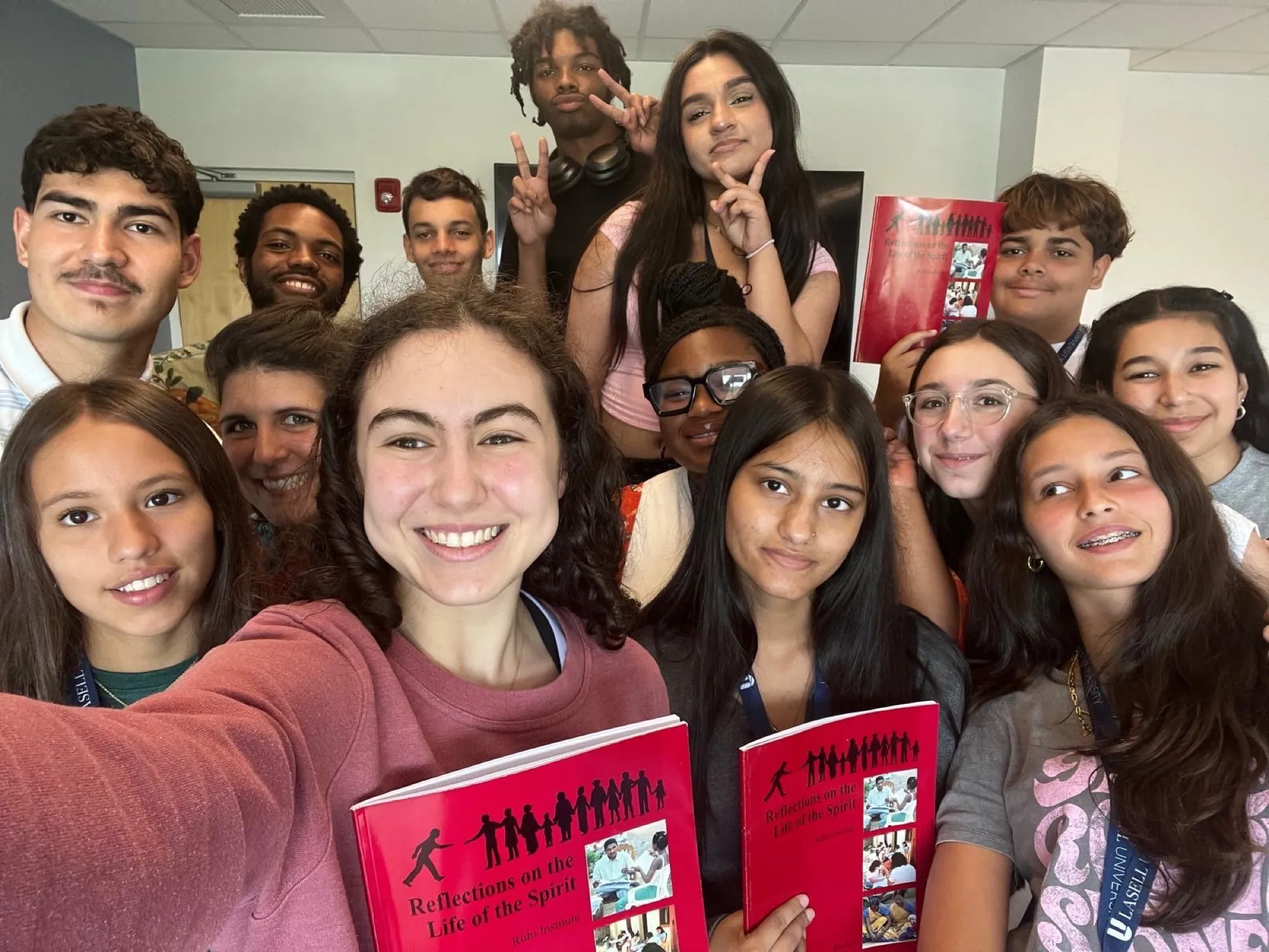Youth group taking a selfie with red study circle books